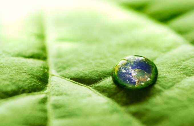 Water drop on a leaf with The Earth reflected inside. Earth picture from Nasa at http://earthobservatory.nasa.gov/